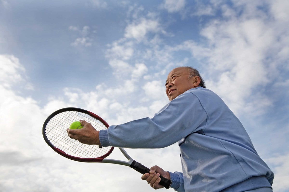 Senior man playing tennis